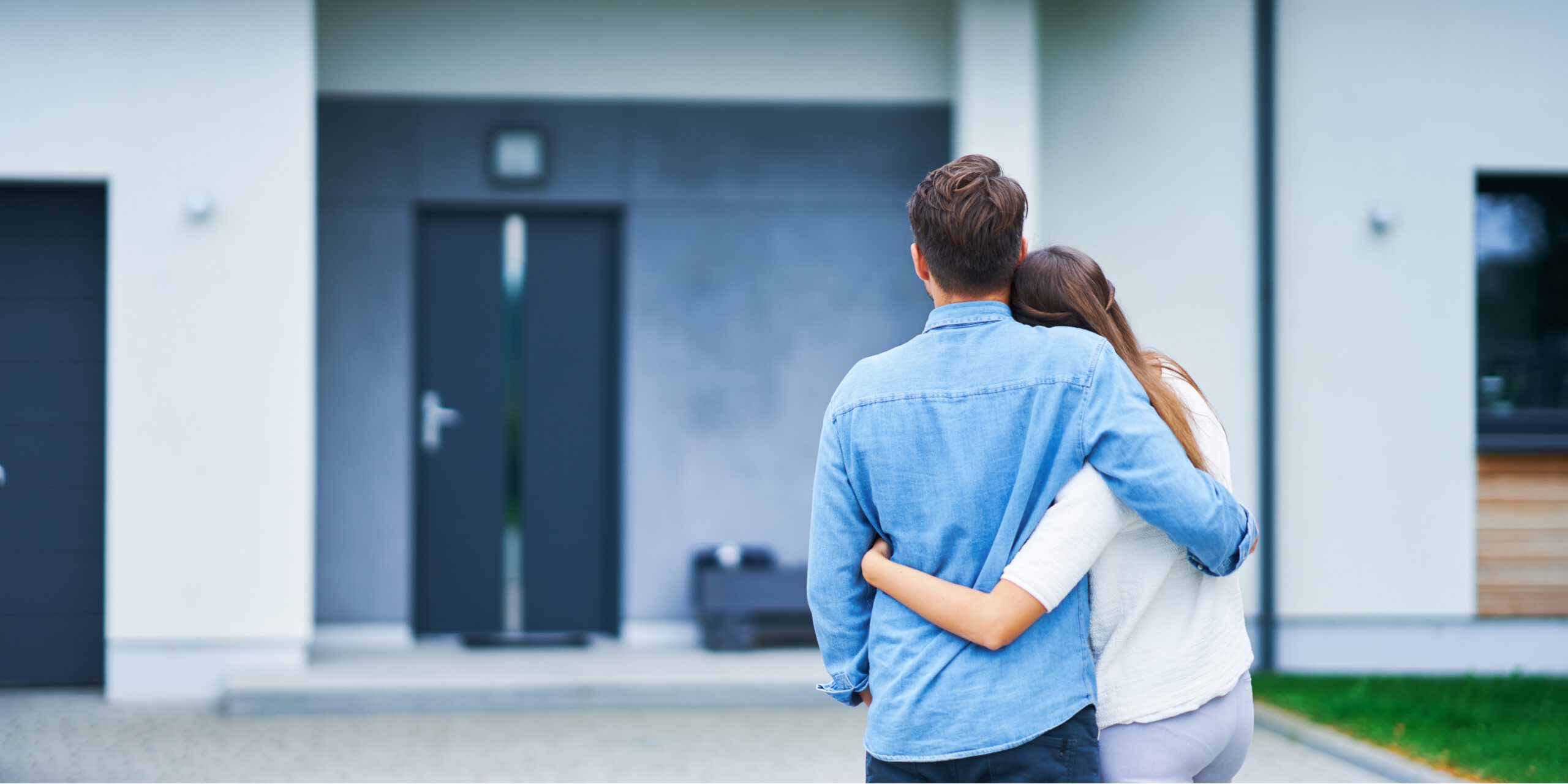 Homeowners enjoying a quiet moment outside their contemporary home